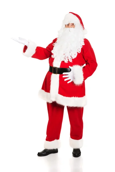 Full length Santa Claus with a welcome gesture — Stock Photo, Image