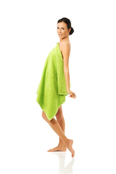 Woman standing wrapped in towel — Stock Photo, Image