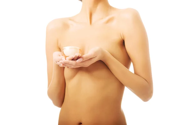 Mulher de topless com recipiente de creme — Fotografia de Stock