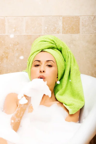 Woman blowing a foam — Stock Photo, Image