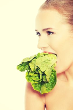 Kafkas üstsüz kadın ağzına marul ile.