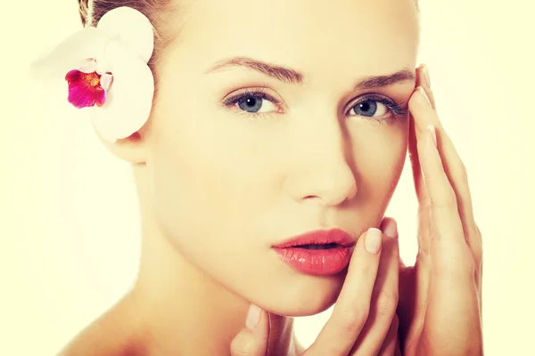 Portrait of beautiful caucasian woman with orchid flower. — Stock Photo, Image