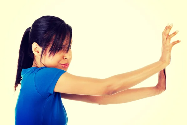 Woman pushing something imaginary — Stock Photo, Image