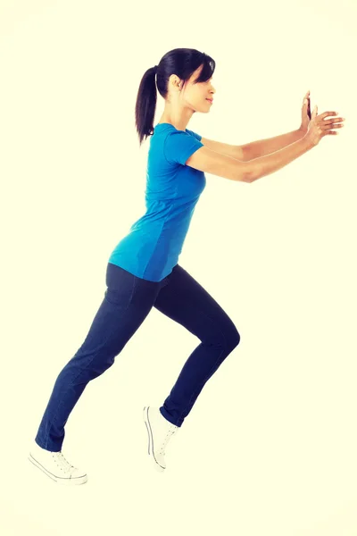 Woman pushing something imaginary — Stock Photo, Image