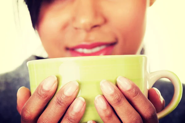 Young woman drinking something from big mug — Stock Photo, Image