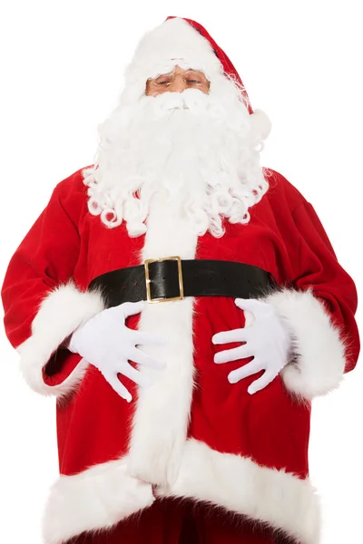 Портрет Санта-Клауса, схватившего его за живот — стоковое фото