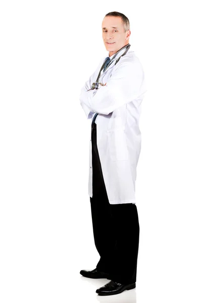 Side view full length male doctor with folded arms — Stock Photo, Image