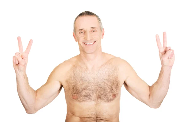 Portrait of mature shirtless man with victory sign — Stock Photo, Image