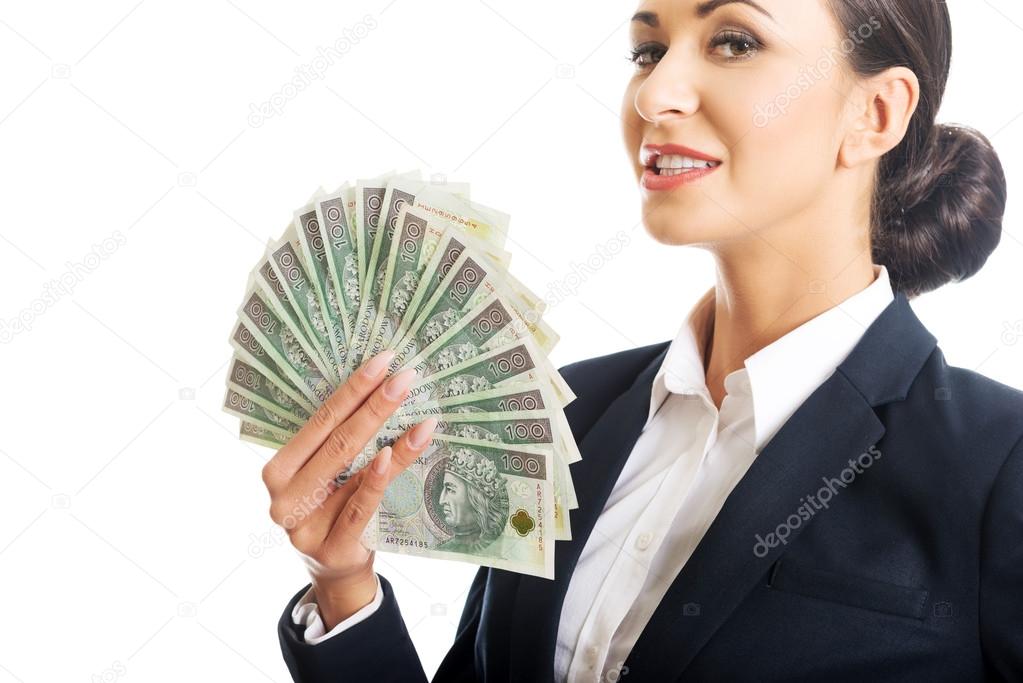 Portrait businesswoman holding a clip of polish money
