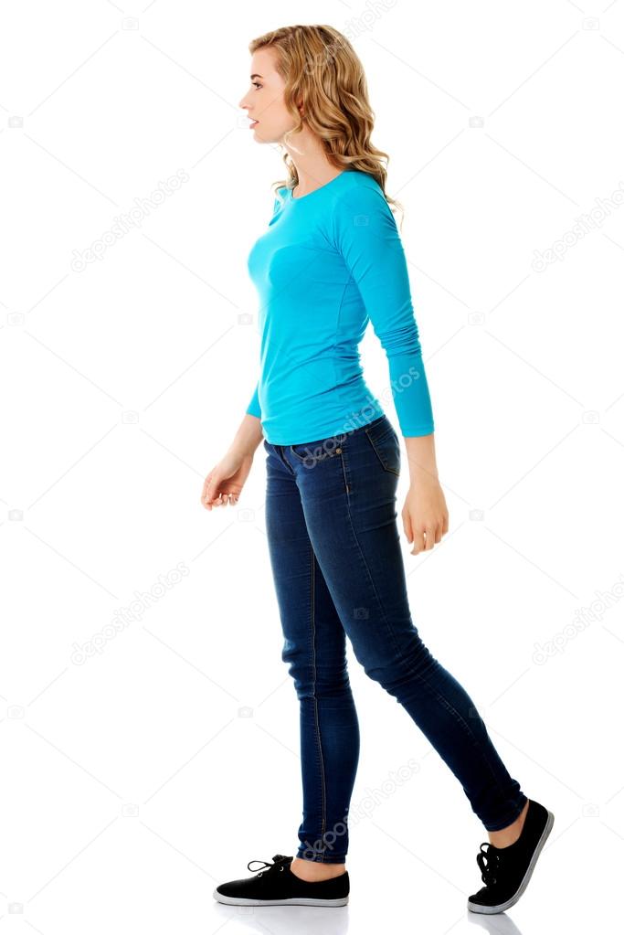 Side view of a woman walking slowly