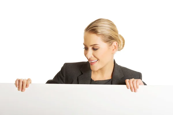 Businesswoman holding empty billboard — Stock Photo, Image