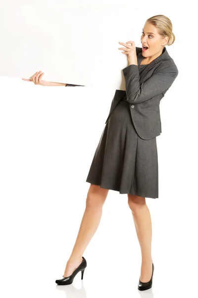 Businesswoman holding empty billboard — Stock Photo, Image