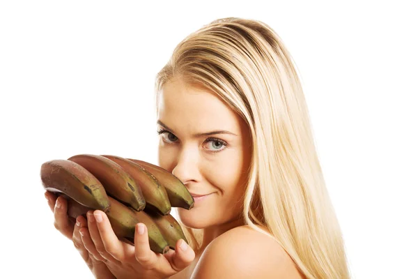 Nude woman holding bananas — Stock Photo, Image