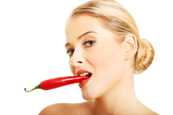 Happy nude woman holding chilli in her mouth — Stock Photo, Image