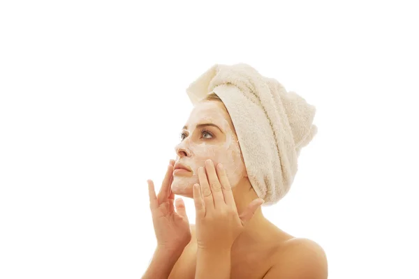 Woman applying a cream on her face — Stock Photo, Image