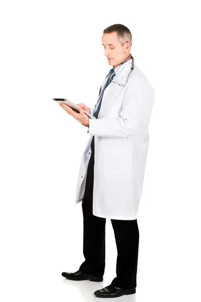 Full length side view male doctor using a tablet — Stock Photo, Image