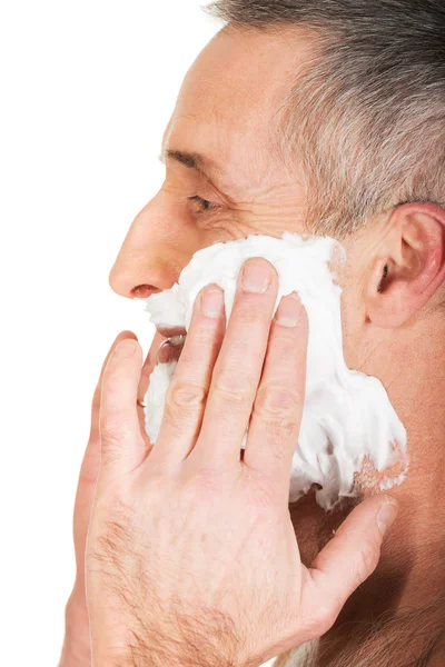 Side view of a man applying shaving foam — Stock Photo, Image