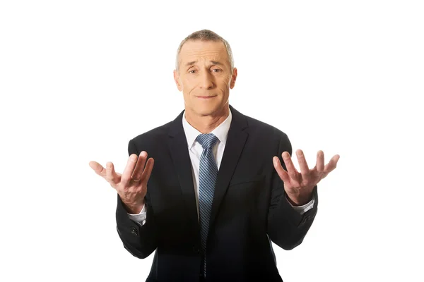 Uomo d'affari con le mani aperte in un gesto indeciso — Foto Stock