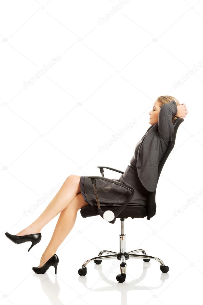Businesswoman resting on armchair
