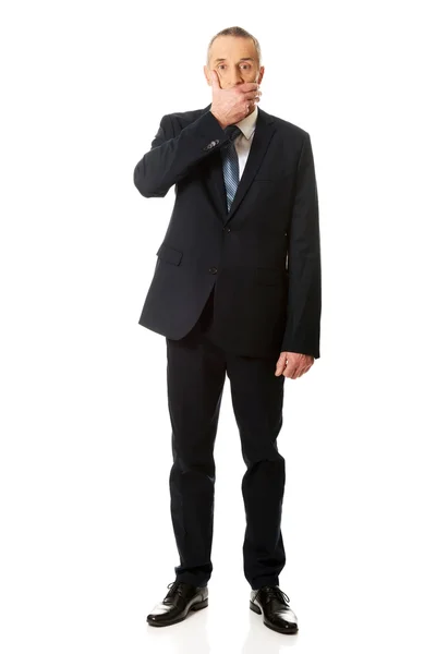 Full length businessman covering mouth — Stock Photo, Image