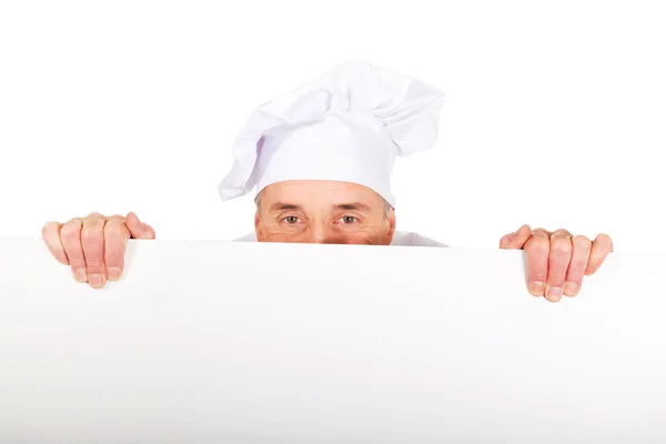 Chef in white uniform holding empty banner — Stock Photo, Image