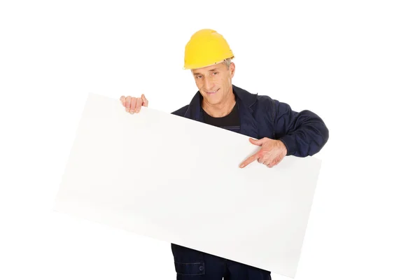 Trabajador feliz presentando banner vacío — Foto de Stock