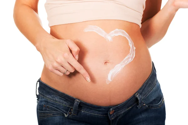 Terhes nő alkalmazó krém a hasán — Stock Fotó