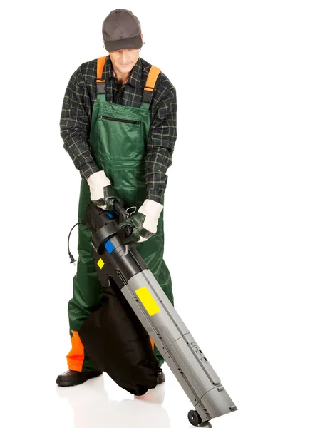 Trabalhador em uniforme com um ventilador de folha — Fotografia de Stock