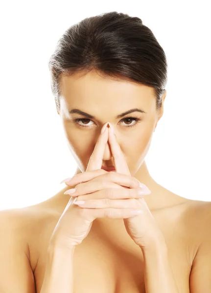 Portrait of serious nude woman holding nose and looking at the camera — Stock Photo, Image