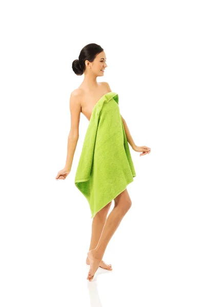 Full length woman standing wrapped in towel — Stock Photo, Image