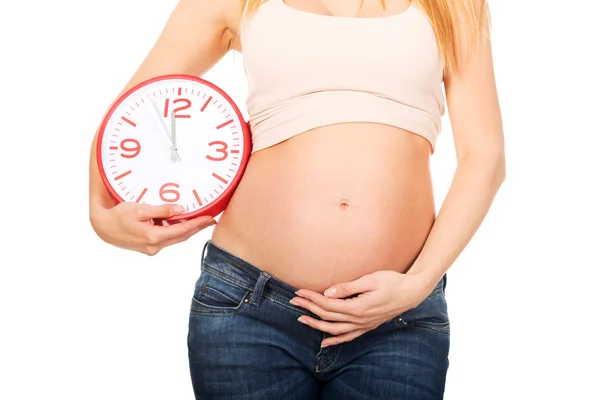 Pregnant woman with a big clock Royalty Free Stock Images