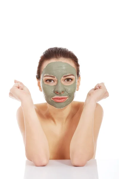 Vrouw in groene gezichtsmasker zitten aan de balie — Stockfoto