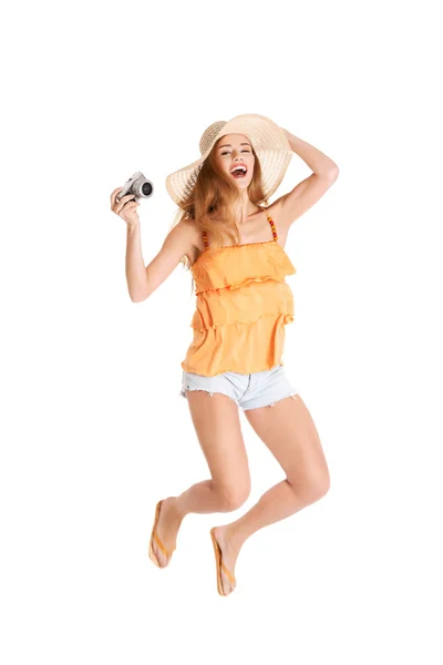 Jumping woman holding a camera — Stock Photo, Image