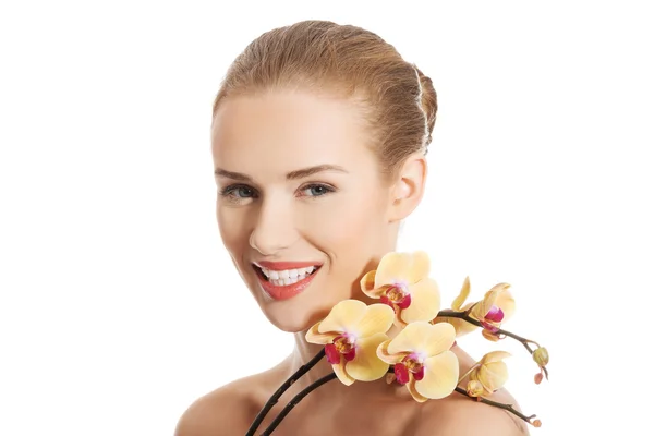 Retrato de mulher nua com uma flor de orquídea — Fotografia de Stock