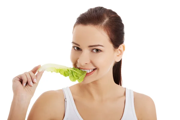 Portrait of a woman eating lettuce leaf — Stock Photo, Image