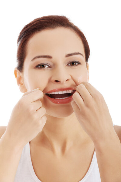 Portrait of woman cleaning teeth with dental floss