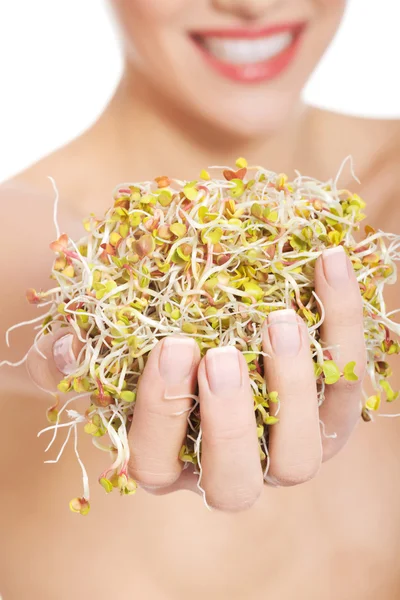 Close up nude woman holding sunflower sprouts — Stock Photo, Image