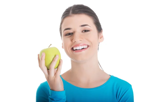 Portrait of happy brunette woman holding an apple — Stock Photo, Image