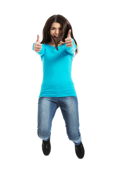 Joven mujer feliz saltando con los pulgares hacia arriba —  Fotos de Stock