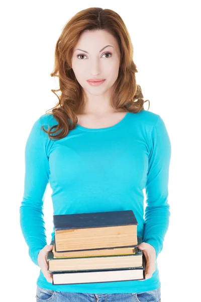 Student woman holding heavy books — Stock Photo, Image