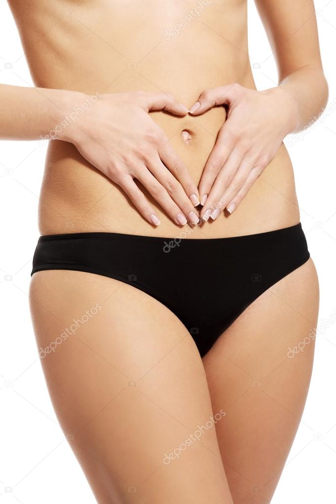 Close up on woman touching her slim belly