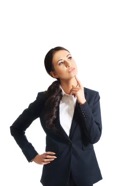 Pensativa mujer de negocios con un dedo bajo la barbilla —  Fotos de Stock