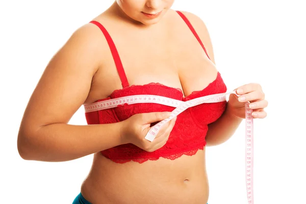 Fat woman measuring breast — Stock Photo, Image