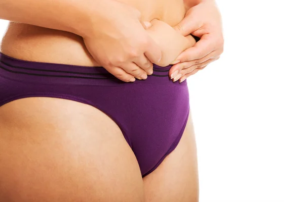 Woman measuring fat belly in underwear — Stock Photo, Image