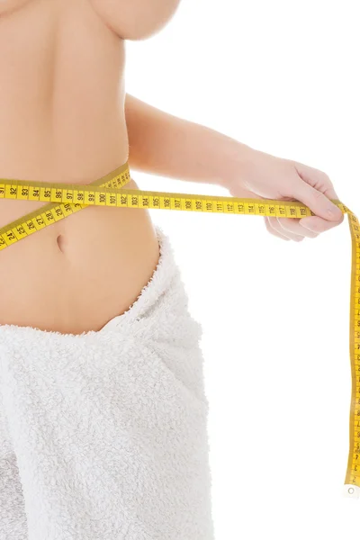 Woman measuring her waistline — Stock Photo, Image