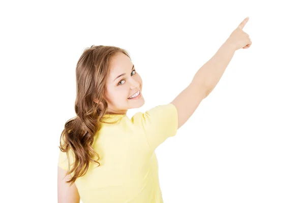 Back view young woman pointing up to the corner — Stock Photo, Image