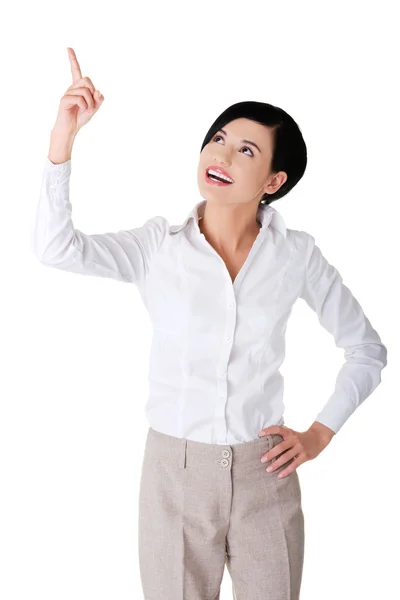 Businesswoman pointing up to the corner — Stock Photo, Image