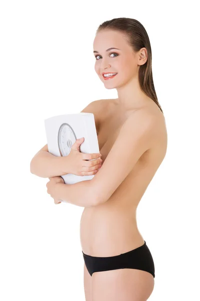 Slim topless woman holding weight — Stock Photo, Image