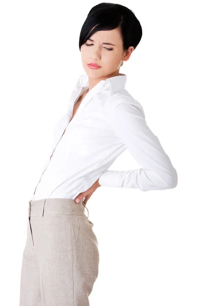 Attractive businesswoman suffers from back pain — Stock Photo, Image