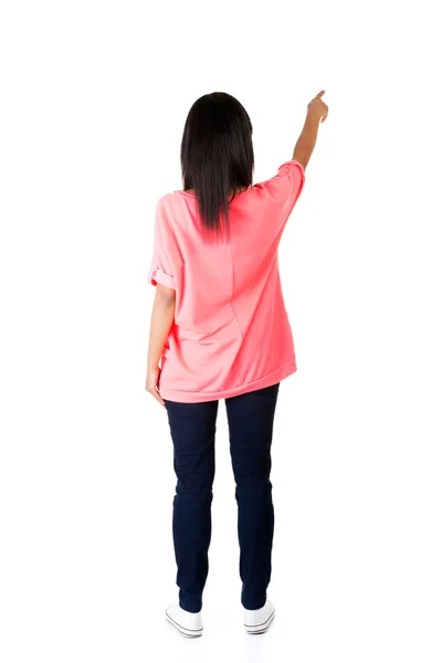 Back view of a woman pointing up — Stock Photo, Image